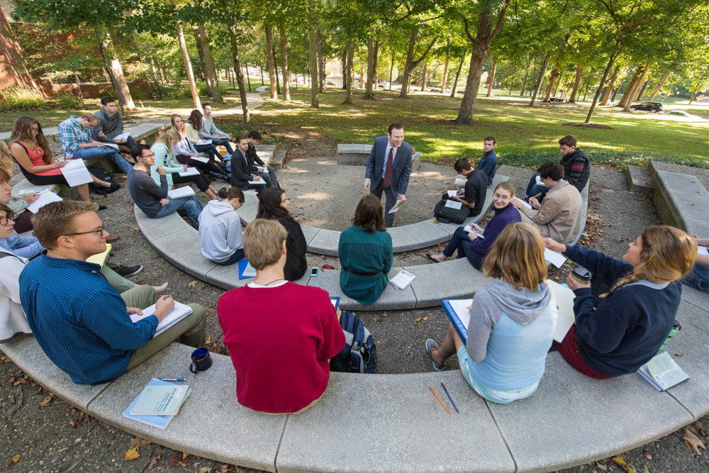 Students attending class outside for a lecture.
